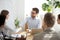 Smiling businessman handshake female employee at meeting