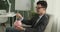 Smiling Businessman Putting Coins into Piggy Bank