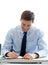 Smiling businessman signing papers in office