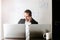 smiling businessman talking on phone sitting at desk