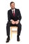 smiling businessman waiting for interview while sitting on wooden chair