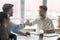 Smiling businessmen get acquainted shaking hands at meeting in office