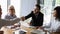 Smiling businessmen handshaking at business briefing, making agreement