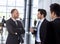 Smiling businessmen talking inside office building