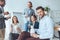 smiling businesspeople eating from paper boxes at office