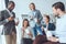 smiling businesspeople eating from paper boxes at office