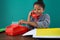 Smiling businesswoman dialing numbers on land line phone