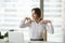 Smiling businesswoman doing office exercises to relieve shoulder