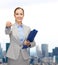 Smiling businesswoman with folder and keys