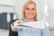 Smiling businesswoman passing a paper