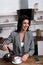 Smiling businesswoman pouring coffee in cup