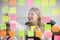 Smiling businesswoman removing sticky papers from scrum board