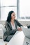 smiling businesswoman siting at table in office