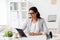 Smiling businesswoman with tablet pc at office