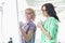 Smiling businesswomen preparing presentation on whiteboard in creative office