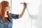 Smiling businesswomen writing on whiteboard in creative office