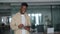 Smiling busy young Black business man using tablet standing in office.