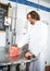 Smiling Butcher Slicing Meat In Machine