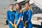 Smiling calm stewardesses posing for the camera