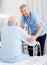 Smiling Caretaker Helping Senior Man With Walking