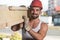 Smiling Carpenter Carrying A Large Wood Plank On His Shoulder