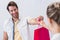 Smiling cashier giving shopping bag to woman