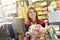 Smiling cashier handing goods to customer