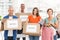 Smiling casual business people with donation boxes