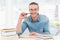 Smiling casual businessman studying at his desk