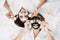 Smiling Caucasian and Asian two girls friends is holding Sliced â€‹â€‹cucumber and relaxing with facial masks for skine care on