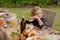 Smiling caucasian boy holding hamburger eating meal with family in garden