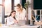 Smiling caucasian businesswomen in formalwear talking while working at modern office