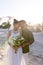 Smiling caucasian newlywed couple with face to face standing at beach at wedding ceremony