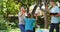 Smiling caucasian parents,son and daughter outdoors collecting plastic waste and high fiving