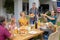 Smiling caucasian senior woman serving family before eating meal together in garden