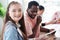 Smiling Caucasian studens girl is holding paintbrush for drawing and painting with watercolor for art with African teacher man in