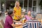 Smiling caucasian woman serving family before eating meal together in garden