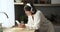 Smiling Caucasian Woman Texting on Phone in the Kitchen