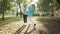 Smiling caucasian women playing soap bubbles in the sunny autumn park. Cheerful grandmother and granddaughter having fun