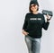 Smiling caucsaian woman in trendy casual grey black outfit for spring summer days. Sweatshirt with funny positive print