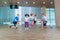 Smiling cheerful kids in school age playing together with jumping rope in gym. Children at physical education lesson in