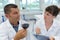 Smiling cheerful positive male winemaker in lab coat