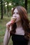 Smiling cheerful ukrainian brunette young woman eating ice cream outdoors