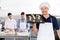 Smiling Chef Carrying Baking Sheet With Dough