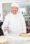 Smiling Chef Dusting Flour On Ravioli Pasta In