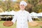 Smiling chef with empty wooden pizza boards in his kitchen street