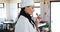 Smiling chef smelling herbs in kitchen