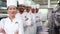 Smiling chefs standing in a line