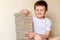 Smiling child with closed eyes and a lot of books