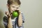 Smiling Child with Green apple.Little Handsome Boy.Health.Fruits